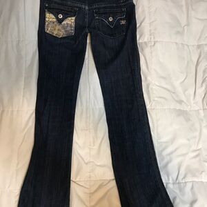 Miss Me Dark Blue Jeans. Back “snakeskin” pocket is damaged from washing
